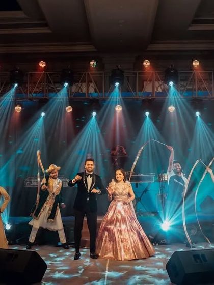 A full Bollywood-themed entry. This couple's entrance featured dancers with ribbons and cold pyro, creating a vibrant and high-energy welcome as they walked in, setting the tone for a fun-filled sangeet.