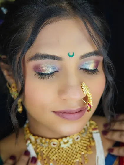 A detailed close-up of a multi-tonal eye makeup look. I love playing with colors to create unique and artistic eyes that match the bride's outfit and personality.