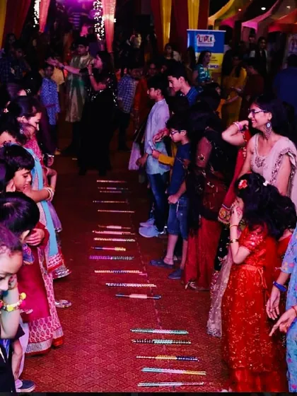 Kids and adults participating in a game during the Dandiya night festivities. I ensure my events have activities for all age groups.