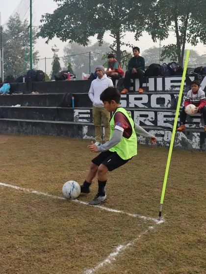 A player practices a corner kick during a league game, a crucial set piece skill we develop in our training sessions.