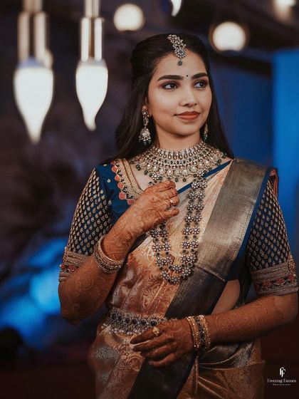 A beautiful portrait of the bride in her reception saree, with soft, elegant lighting.