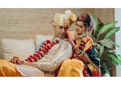 A quiet moment indoors for Rutika and Devendra. The traditional Maharashtrian attire and the loving gesture create a beautiful, classic image.