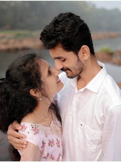 A sweet and gentle moment by the river. The natural setting and soft colors enhance the romance of this couple portrait.