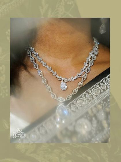 A close-up of the layered AD necklace, showing the different designs and the beautiful teardrop pendants.