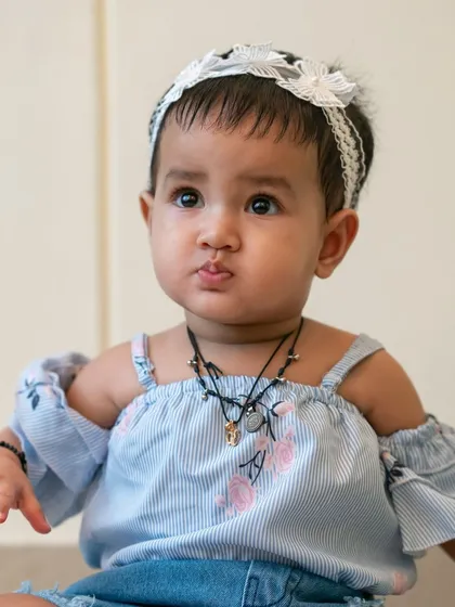A close up portrait of the baby girl, her cute, pouty expression making for a memorable photo.