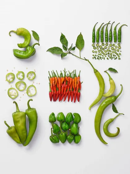 This is a deconstructed food portrait of chillies. This knolling photography technique is perfect for infographics, packaging, or modern cookbooks, as it displays the product in a clean and organized way.