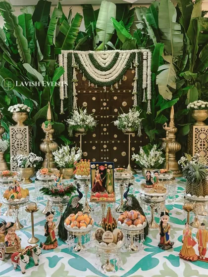 We honor tradition with a modern twist. This traditional South Indian engagement setup features lush banana leaves, jasmine garlands, and intricate cultural details for a timeless celebration.