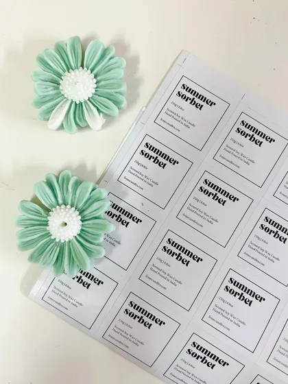 Studio days. A look at our "Summer Sorbet" labels and the matching daisy wax toppers before they go into the jars.