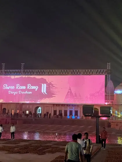 Spectators gather before the main event in Ayodhya, with our full stage and lighting truss visible in the background. We manage every detail, from audience logistics to the final technical execution.
