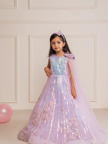 Make her fairytale dreams come true with our lilac butterfly gown. This enchanting piece features a sequined bodice, delicate butterfly accents, and a flowing cape, perfect for a themed birthday party or a magical photoshoot.