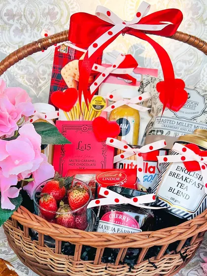 The perfect romantic gesture, this 'Breakfast in Bed' basket is designed for a luxurious morning. It includes fresh strawberries, premium English breakfast tea, cherry jam, Nutella, and salted caramel hot chocolate, all beautifully arranged in a classic wicker basket with red and pink accents.