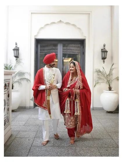 My beautiful Anand Karaj bride Manpreet, walking with her husband. She looks so graceful and elegant in her traditional red suit.