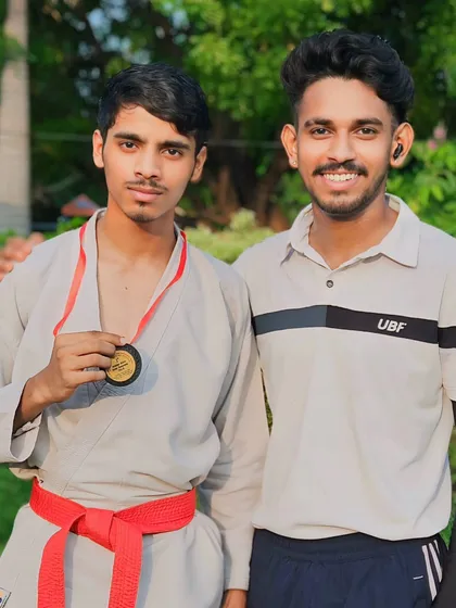 This red belt student is a formidable competitor. His medal is a testament to his advanced skills and dedication.