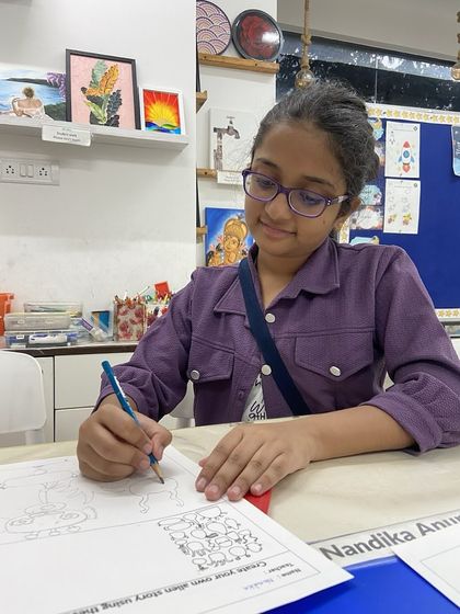 This student is working on a story creation worksheet, using visual prompts to build her own narrative. This activity combines drawing with storytelling to spark imagination and creativity.