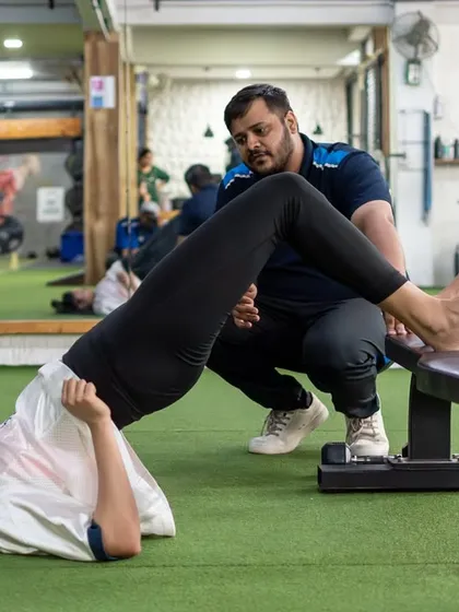 Rehab is not about rest; it's about smart adaptation. Here, one of our physiotherapists guides a client through a hip bridge, ensuring every movement trains the right patterns to build strength and stability while protecting the body.