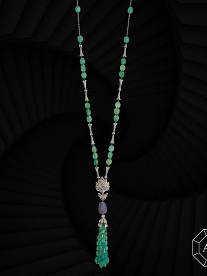 Our exquisite lariat necklace features emerald tumbles, sapphires, rose-cut and round diamond enhancers, and a striking diamond pendant at its center.