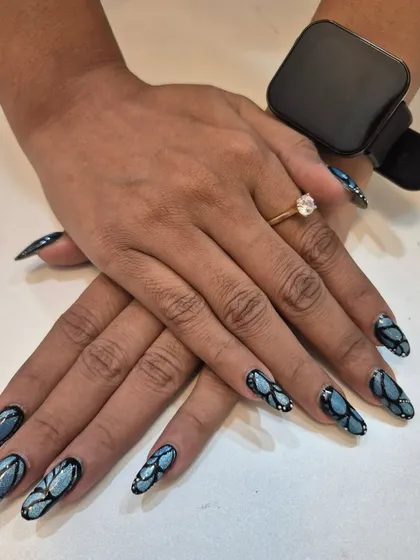 This is where nails become art. I designed this intricate, multi-tonal blue and black pattern on long almond-shaped extensions. This style is perfect for when you want a truly unique and eye-catching look that expresses your personality.