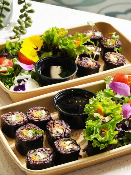 Beautifully plated sushi and salad boxes, ready for takeaway. This image highlights the convenience and quality of healthy meals on the go.