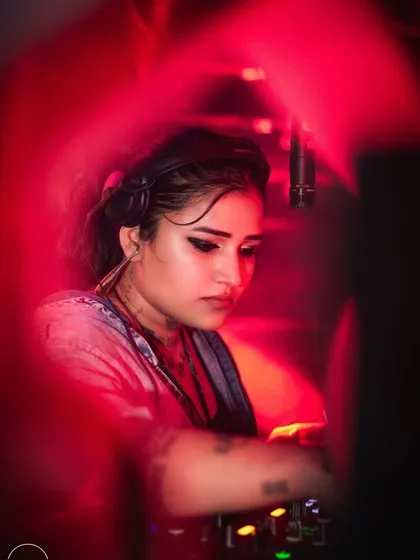 A creative, moody shot of me mixing, seen through a red filter.