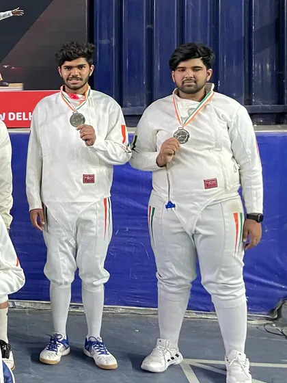 Two of our senior fencers showing off their silver medals after a tough competition at the state level.