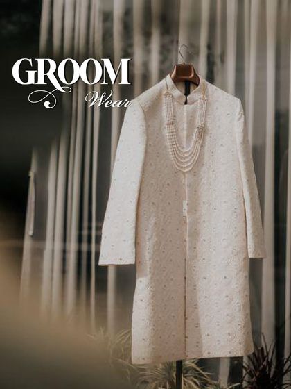 The quintessential groom's attire. This classic off-white sherwani, paired with a traditional pearl necklace, awaits its moment to make a wedding day truly majestic.