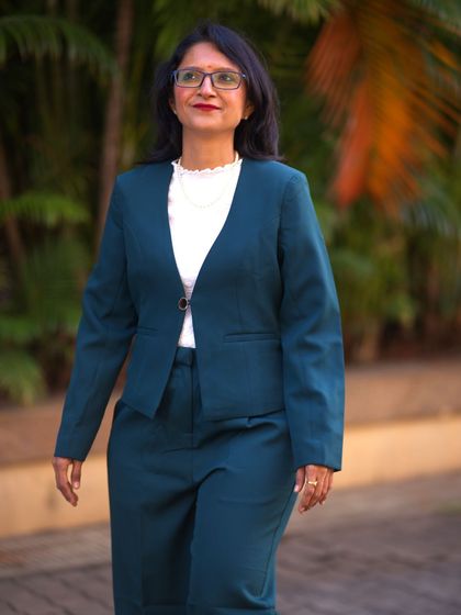 A photo of me in a green suit. Writing is a responsibility. By documenting your experiences, you preserve a piece of your culture and heritage for future generations.