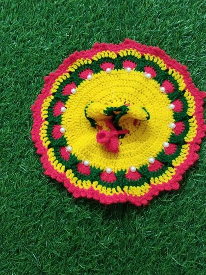A vibrant woolen dress in yellow, green, and red. This multi-colored poshak is decorated with white pearls and is sure to keep your Laddu Gopal warm and stylish.