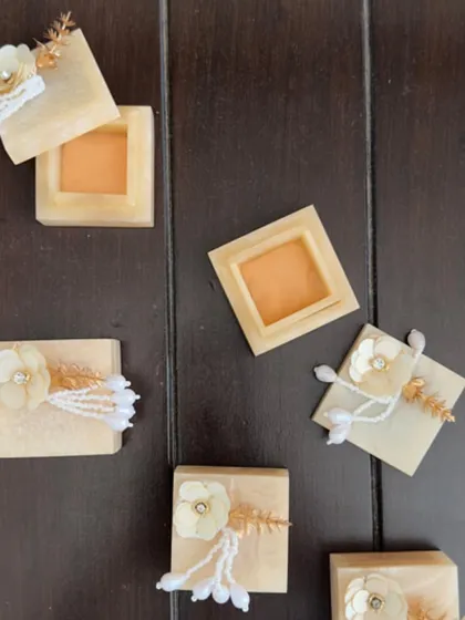 These small, square resin boxes are adorned with delicate flowers and pearl tassels. They are a beautiful and modern way to present a small gift or shagun.