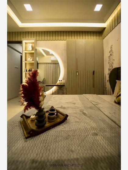 A detail shot of the dressing table in a master bedroom. The large, backlit circular mirror provides excellent lighting and serves as a beautiful design feature.