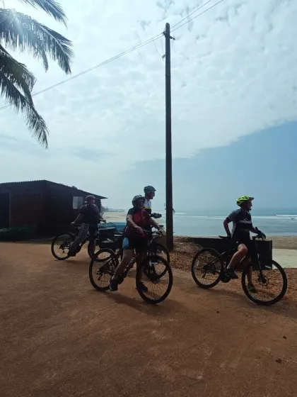 Cyclists looking out at the Arabian Sea. Reaching the coastline is a major milestone on our 10-day journey from Mysore to Goa, and the view is always worth the effort.
