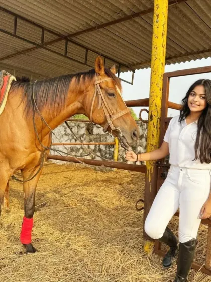 A rider stands with her horse in the stables. The time spent before and after the ride is just as important for building a bond.
