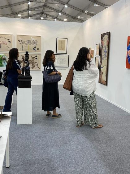 A view of the booth showing the mix of paintings, sculptures, and works on paper.
