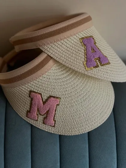 Getting ready for a sunny bachelorette or girls' trip? Our personalised straw visor hats, shown here with custom initials 'A' and 'M', are a chic and practical accessory.
