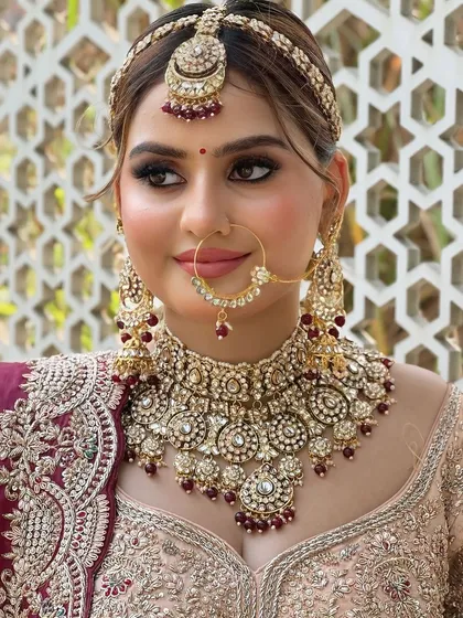 A slightly different angle of the same bride, capturing her gentle smile and the perfect symmetry of her makeup.