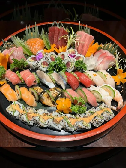 This stunning sushi platter is a work of art, meticulously arranged by our passionate team. It features a diverse selection of our finest nigiri, sashimi, and maki rolls, showcasing the skill and tradition that goes into every dish we create.