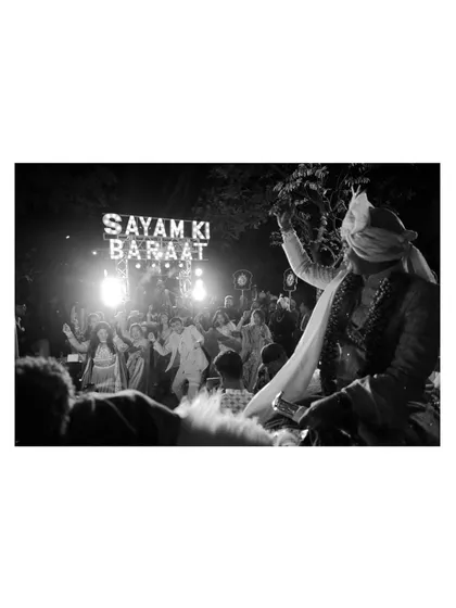 The groom's baraat, a lively and energetic procession, captured at the beautiful Ananta resort in Udaipur.
