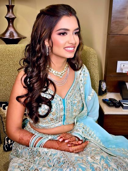 A candid shot of Yashvi, looking radiant and happy in her stunning ice-blue lehenga for her reception.