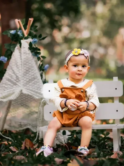 A cute and rustic outdoor portrait with a teepee and fallen leaves.