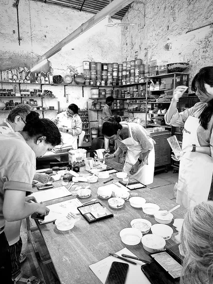Students in our masterclass preparing their own glaze test tiles. This practical work is essential to understanding the theory.