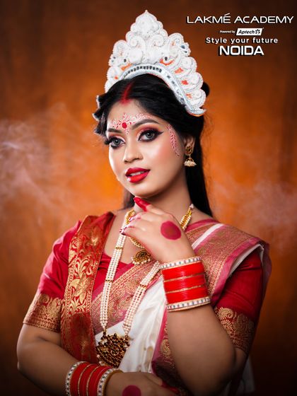 A classic Bengali bridal portrait. The combination of the red bindi, white chandan, and bold red lip is a timeless look that is a cornerstone of our bridal curriculum.