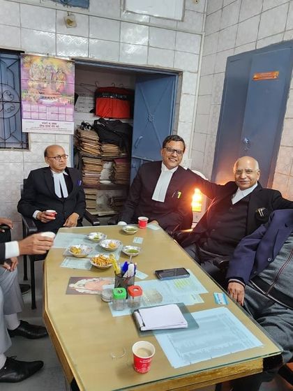 A candid discussion in my father's chambers in Meerut. The wisdom and experience shared in these rooms have shaped generations of lawyers.