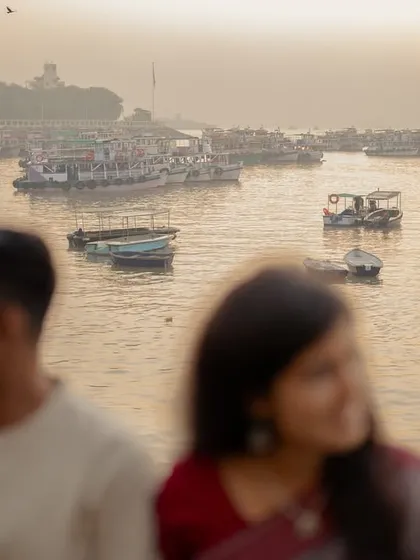 An artistic shot using a shallow depth of field, with the couple out of focus and the serene harbor as the subject. This composition suggests a shared, private world against a beautiful backdrop.