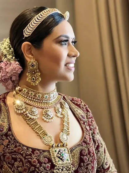 A side view of a bride with a classic floral bun, a perfect choice for a timeless and elegant wedding day hairstyle.