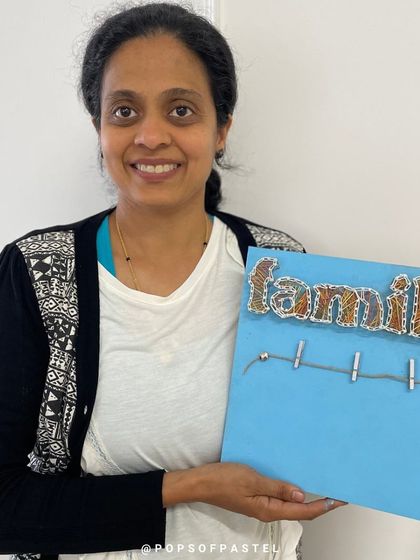 This artist chose a bright blue background for her "Family" string art, making the final piece pop with color.