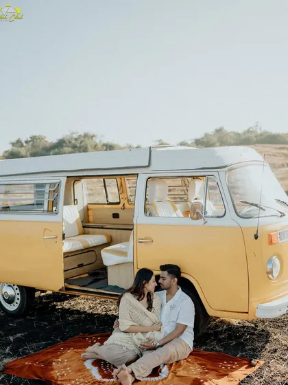 A cozy moment inside the vintage van, with the couple looking out over a picnic blanket. It’s a perfect blend of adventure and intimacy.