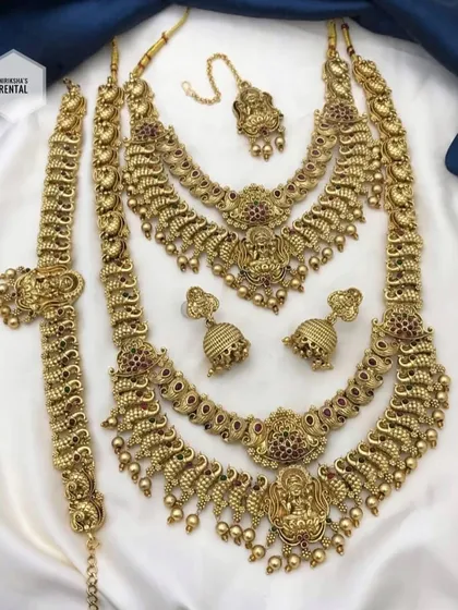 A complete and grand temple jewellery set for rent, including a choker, two long necklaces, earrings, and an armlet (vanki).