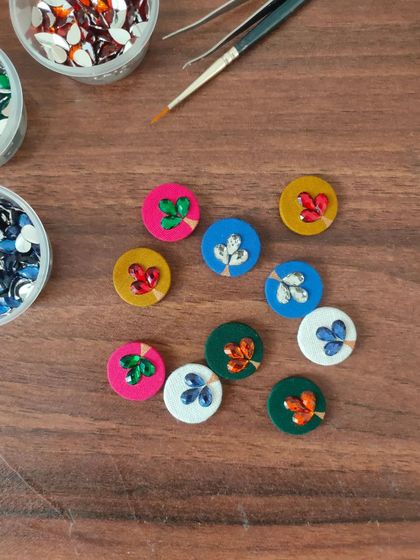 A glimpse of my work-in-progress materials. You can see colorful fabric components, beads, threads, and hand-painted pieces all waiting to be turned into beautiful jewelry.