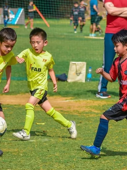Two players battling for the ball. We empower each player to reach their fullest potential, both on and off the field.