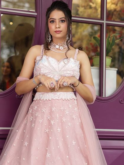 A perfect bridesmaid or engagement look featuring our light pink lehenga with star embellishments. It's a youthful and dreamy option for your portfolio.