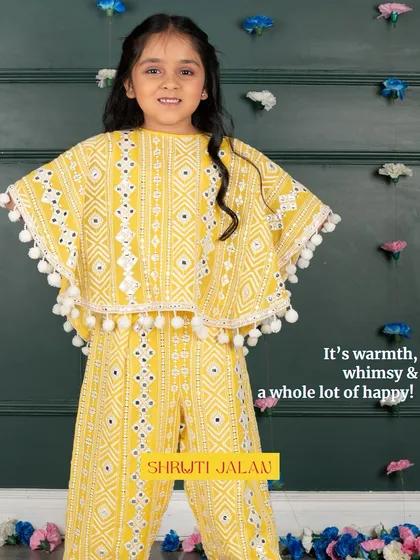 It's warmth, whimsy, and a whole lot of happy. This yellow cape set with pom-pom trim is guaranteed to bring a smile to her face.
